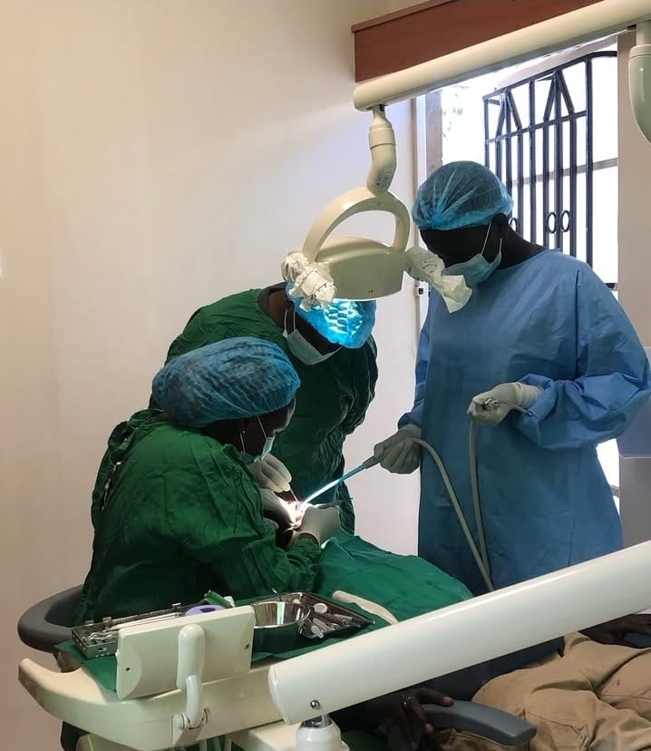 A doctor working on a patient's teeth.